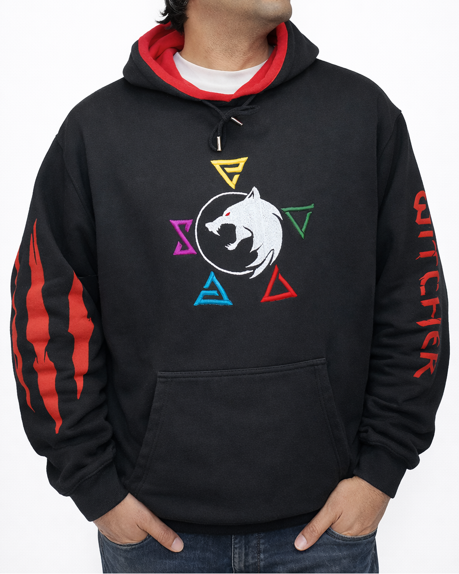 Man wearing a black hoodie with colorful symbols and 'Witcher' branding on a white background